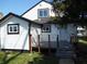 Home exterior features black trim, a deck, a white door, and vinyl siding at 1545 Finley Ave, Indianapolis, IN 46203