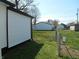 Large backyard with green grass, chain link fence, and white vinyl siding at 1545 Finley Ave, Indianapolis, IN 46203