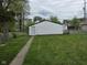 View of the backyard featuring a detached garage and a grassy area at 1545 Finley Ave, Indianapolis, IN 46203