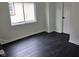 Bright bedroom features new flooring, neutral wall color, and a window with blinds at 1545 Finley Ave, Indianapolis, IN 46203