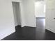 Bright bedroom with black stained wood flooring and white walls at 1545 Finley Ave, Indianapolis, IN 46203