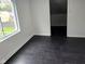 Bright, airy bedroom with hardwood flooring and a view of the outdoors at 1545 Finley Ave, Indianapolis, IN 46203