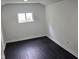 Bedroom featuring black wood-look floors and a window at 1545 Finley Ave, Indianapolis, IN 46203