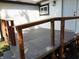 Exterior back deck painted gray with wood railing, adjacent to white vinyl siding at 1545 Finley Ave, Indianapolis, IN 46203