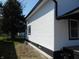 Home's exterior with white siding and black trim plus green grass at 1545 Finley Ave, Indianapolis, IN 46203