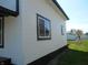 Home's exterior shows white siding with black trim and well manicured lawn at 1545 Finley Ave, Indianapolis, IN 46203