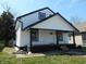 Two-story home featuring white siding, a covered porch, and black accent trim at 1545 Finley Ave, Indianapolis, IN 46203