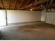 Large garage with white door, unpainted drywall, and painted floor at 1545 Finley Ave, Indianapolis, IN 46203