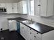 Spacious kitchen featuring white cabinets, stainless steel sink, and modern appliances at 1545 Finley Ave, Indianapolis, IN 46203