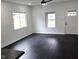 Bright and airy living room featuring updated dark hardwood floors, large windows, and white walls at 1545 Finley Ave, Indianapolis, IN 46203