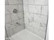 Newly renovated bathroom shower with marble-style walls at 1545 Finley Ave, Indianapolis, IN 46203