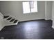 Minimalist staircase with dark-stained wood steps, contrasting white trim, and a large window at 1545 Finley Ave, Indianapolis, IN 46203