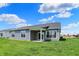 Back exterior of a single-story home with a covered patio and a spacious, well-maintained lawn at 1639 Clover Crossing Dr, Greenfield, IN 46140