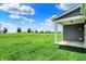 Spacious backyard with a covered patio, offering ample green space and outdoor living potential at 1639 Clover Crossing Dr, Greenfield, IN 46140
