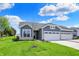 Attractive single-story home with a two-car garage, stone accents, and a well-maintained lawn at 1639 Clover Crossing Dr, Greenfield, IN 46140