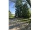 Large backyard features a basketball hoop surrounded by mature trees, perfect for outdoor activities at 1725 E 100 S, Lebanon, IN 46052