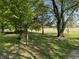 Serene backyard with mature trees, providing shade and a peaceful outdoor setting at 1725 E 100 S, Lebanon, IN 46052