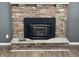 Close-up of brick fireplace with black metal insert in living room at 1725 E 100 S, Lebanon, IN 46052