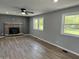 Living room with brick fireplace, ceiling fan, and natural light from windows at 1725 E 100 S, Lebanon, IN 46052