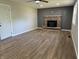 Living room featuring new flooring and a charming brick fireplace at 1725 E 100 S, Lebanon, IN 46052