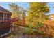 Lush backyard featuring colorful fall foliage, a deck, and a trampoline, perfect for outdoor enjoyment at 1832 Live Oak Ct, Avon, IN 46123