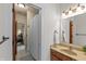 Bathroom with a wood vanity, decorative mirror, and shower with a curtain at 1832 Live Oak Ct, Avon, IN 46123