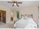 Bedroom features a ceiling fan and opens to a closet and an attached bathroom at 1832 Live Oak Ct, Avon, IN 46123