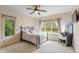 Sun-filled bedroom boasts a ceiling fan, neutral carpet, and large windows at 1832 Live Oak Ct, Avon, IN 46123