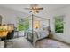 Bedroom featuring a four poster bed, ceiling fan, and desk at 1832 Live Oak Ct, Avon, IN 46123