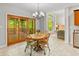 Dining area with wood table and chairs and sliding glass doors with a view at 1832 Live Oak Ct, Avon, IN 46123