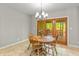 Dining area with wood table and chairs, chandelier, and sliding glass doors with a view at 1832 Live Oak Ct, Avon, IN 46123