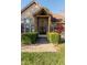 Covered entryway featuring a brick walkway and manicured hedges leading to double front doors at 1832 Live Oak Ct, Avon, IN 46123