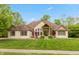 Stunning single Gathering home featuring a stone and brick facade, manicured lawn and mature trees at 1832 Live Oak Ct, Avon, IN 46123