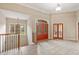 Bright foyer with tiled floor, featuring a staircase and red French doors leading to another room at 1832 Live Oak Ct, Avon, IN 46123