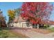 Spacious three car garage with brick paver driveway surrounded by colorful fall foliage at 1832 Live Oak Ct, Avon, IN 46123