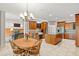 Open concept kitchen featuring wood cabinets, stainless appliances, granite island, and dining area at 1832 Live Oak Ct, Avon, IN 46123