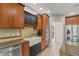 Close up on the kitchen's apron sink, stone backsplash, stainless dishwasher, and granite countertops at 1832 Live Oak Ct, Avon, IN 46123