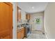 Well-equipped laundry room features modern washer and dryer, ample cabinet space, and exterior access at 1832 Live Oak Ct, Avon, IN 46123