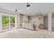 Spacious living room featuring plush carpeting, built-in shelving, and sliding glass doors to the backyard at 1832 Live Oak Ct, Avon, IN 46123
