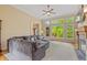 Cozy living room with a large sectional sofa, fireplace, and windows overlooking the outdoor deck at 1832 Live Oak Ct, Avon, IN 46123