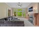 Bright living room featuring a stone fireplace, built-in shelving, and large windows with a view at 1832 Live Oak Ct, Avon, IN 46123