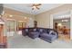 Spacious living room with fireplace, large sectional, and open layout leading to dining area and foyer at 1832 Live Oak Ct, Avon, IN 46123