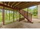 Charming brick patio with a porch swing, offering a relaxing outdoor space under a wooden deck structure at 1832 Live Oak Ct, Avon, IN 46123