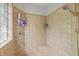 Tiled walk-in shower equipped with shower caddy, rainfall shower head, and corner seat at 1832 Live Oak Ct, Avon, IN 46123