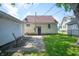 Backyard patio with a detached garage and partial fence at 1912 Broadway St, Anderson, IN 46012