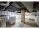 Spacious unfinished basement with exposed pipes and laundry hookups at 1912 Broadway St, Anderson, IN 46012