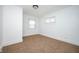 An empty bedroom offers neutral carpet, white walls, and natural light at 1912 Broadway St, Anderson, IN 46012