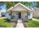 Charming home featuring a cozy front porch and a well-maintained lawn with fresh landscaping at 1912 Broadway St, Anderson, IN 46012