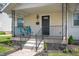 Close-up of a cute front porch with a small seating area and freshly planted landscaping at 1912 Broadway St, Anderson, IN 46012