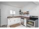 Renovated kitchen featuring stainless steel appliances, white cabinets, and an abundance of natural light at 1912 Broadway St, Anderson, IN 46012
